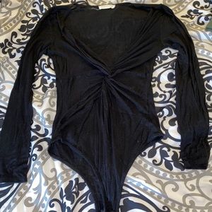 Twisted black body suit
